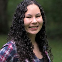 Color headshot of Alana Rigby in a flannel shirt.