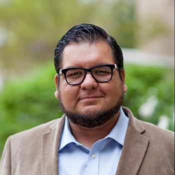 Color headshot of Cesar Soto in a suit.