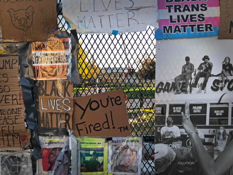 Protest banners on the fence, looking through to the White House