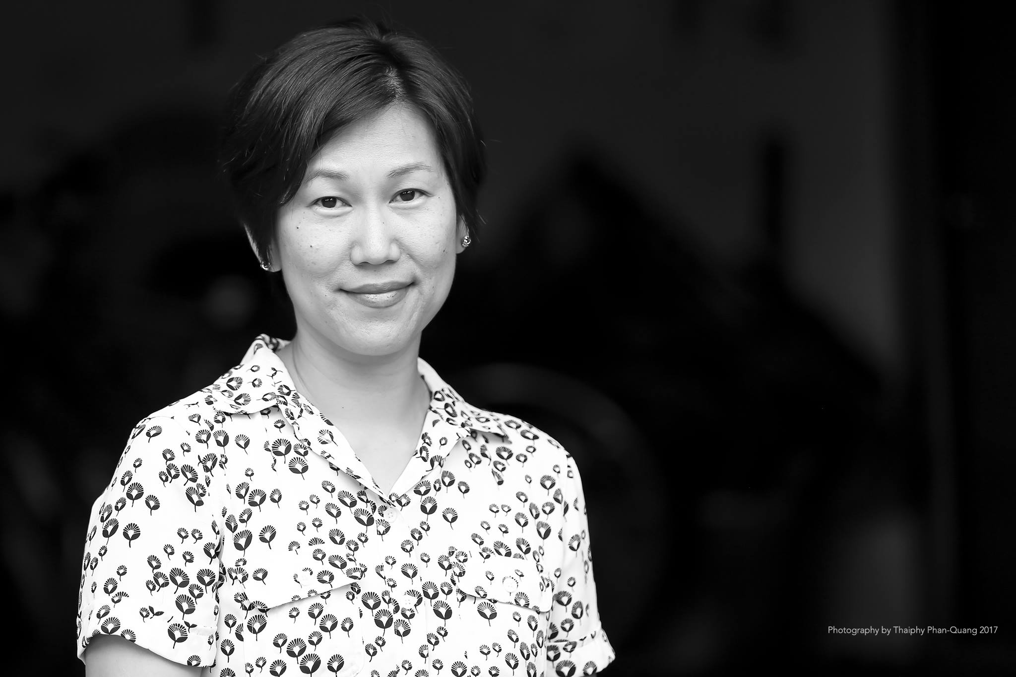 Black and white headshot of Jennifer Kwon Dobbs in a patterned button down shirt.