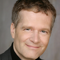 Color headshot of Andrew Elfenbein wearing a black shirt.