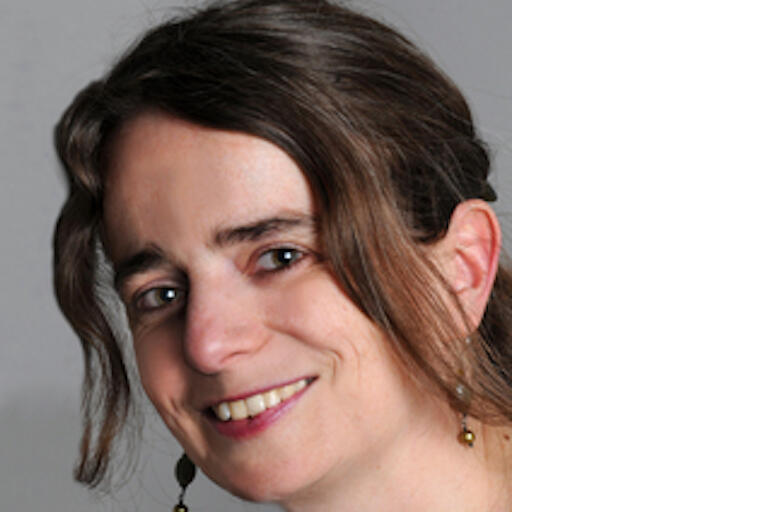 Color headshot of Anne-Lise François in front of a gray background.