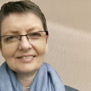 Color headshot of Averill in a blue scarf.
