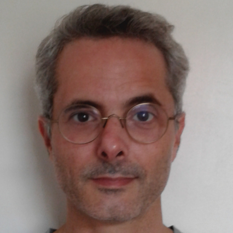 Color headshot of Cardoso wearing round wire glasses.