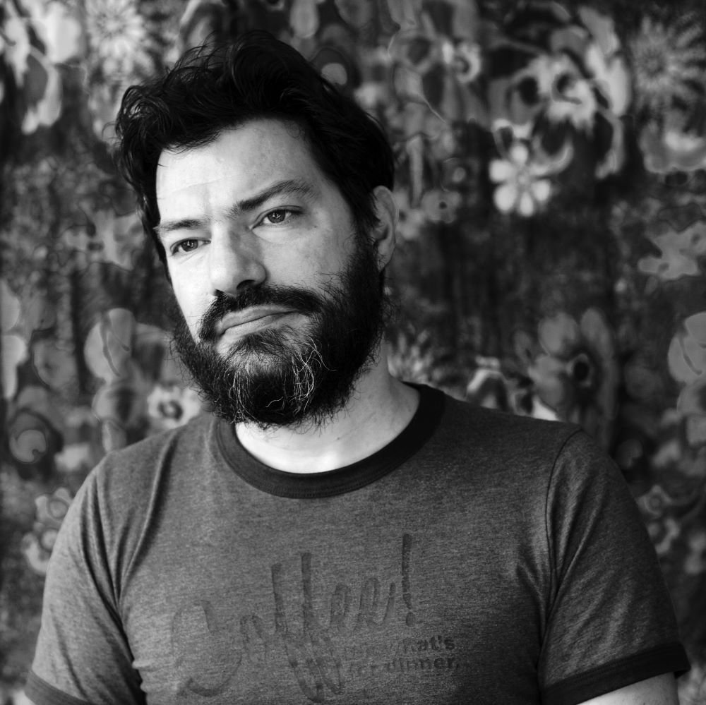 Black and white headshot of Andrew Kozma.