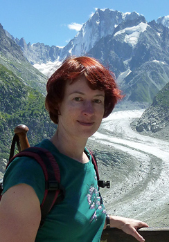 Color photograph of Angela Esterhammer in front of a snowy mountain.