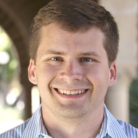 Color headshot of Ben Wiebracht wearing a blue collared shirt standing outside. 