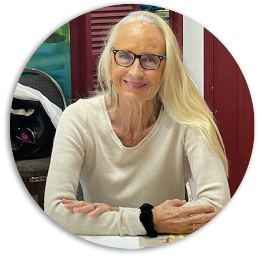 Color photograph of Catherine Burroughs in a white top and glasses.