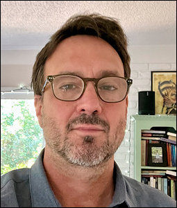 Color headshot of Tony Jarrells wearing glasses.