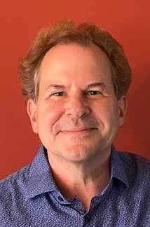 Color headshot of Adam Potkay in a dark blue collared shirt.