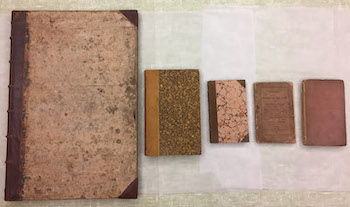 Figure 9: Comparative sizes of the first five editions of the Guide (left 
                                to right): first ed. (Select Views, 1810, 20 x 13.5” [508 x 343mm]); second ed. 
                                (River Duddon, 1820, 9 x 6” [230 x 150mm]); third ed. 
                                (Description, 1822, 6.5 x 4” [166 x 100mm]); fourth ed. 
                                (Description, 1823, 6.5 x 4” [166 x 100mm]); fifth ed. 
                                (Guide, 1835, 7 x 4.5”, [180 x 110mm]). (Courtesy: Wordsworth Trust)