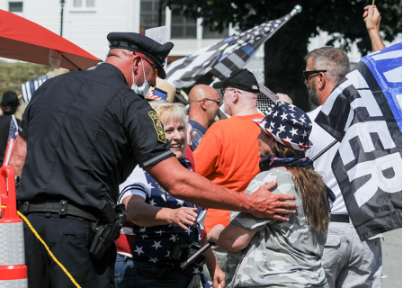 Figure 3: Peabody, Massachusetts police officer James Festa talking with protesters at Dianna Ploss’s rally by Jaime Campos of The Salem News